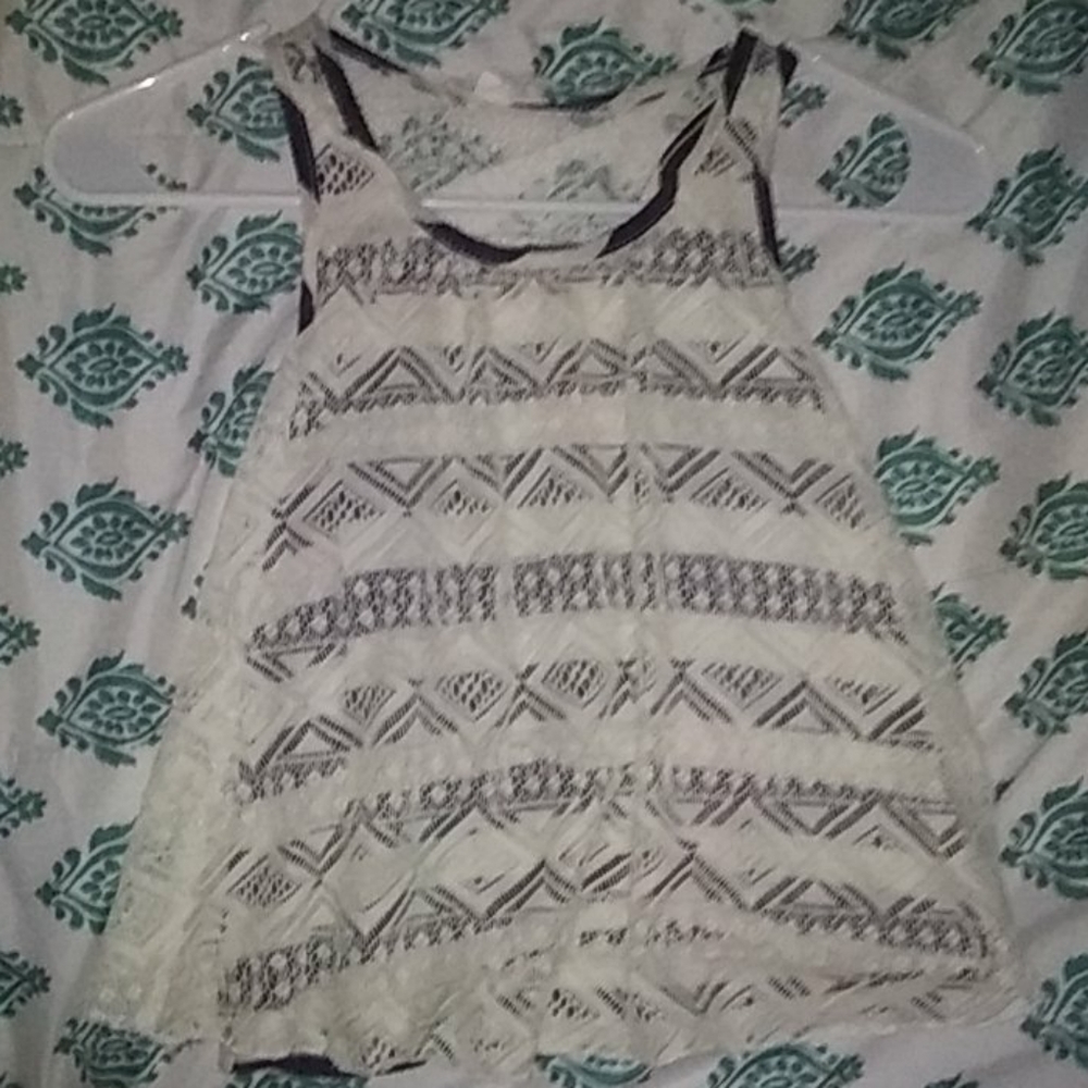 A blue and white stripped shirt with lace over it.